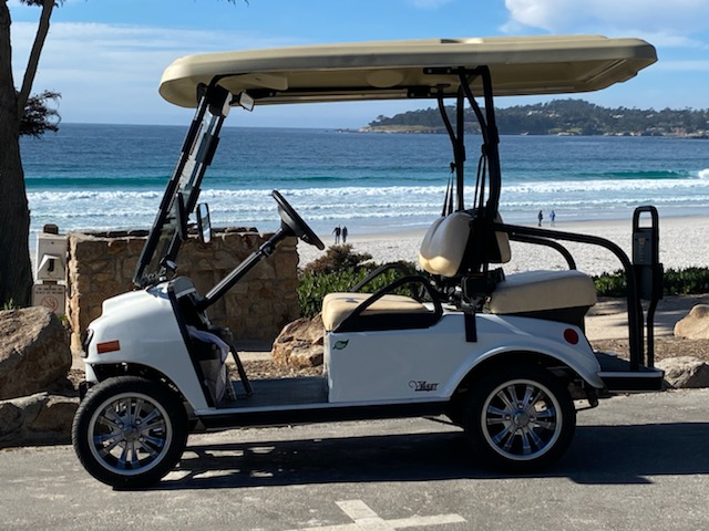 Street-legal electric golf cart parked at Carmel Beach